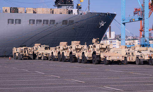 U.S. Military vehicles wait to be loaded onto the United States Naval Ship Bob Hope in the Port of Tacoma, Wash. May 25, 2023, by the 833rd Transportation Battalion. The operation is part of the largest Army deployment in the Pacific since the Vietnam War. (U.S. Army photo by Pfc. Leif Jensen)