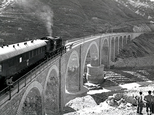 Diesel-Electric Locomotive crossing a bridge during World War II.