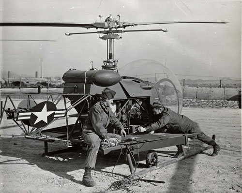 The H-13 Sioux worked on by mechanics.